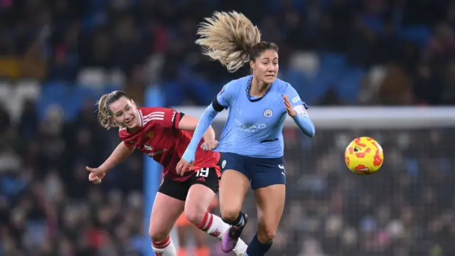 Laia Aleixandri of Manchester City is challenged by Elisabeth Terland of Manchester United during the Barclays Women's Super League match between Manchester City and Manchester United