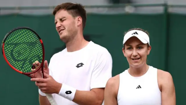 Henry Patten of Great Britain reacts as he plays with Olivia Nicholls of Great Britain