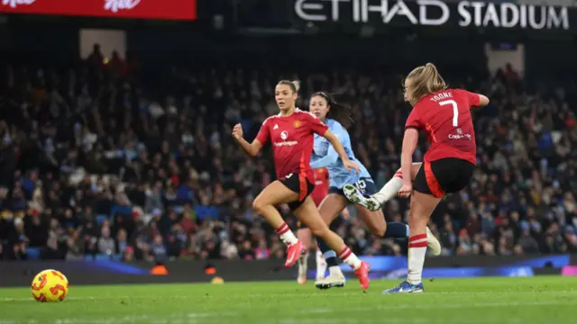 Ella Toone of Manchester United scores her team's third goal during the Barclays Women's Super League match between Manchester City and Manchester United