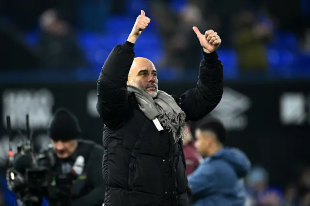 Pep Guardiola, Manager of Manchester City, gives a thumbs up to the fans