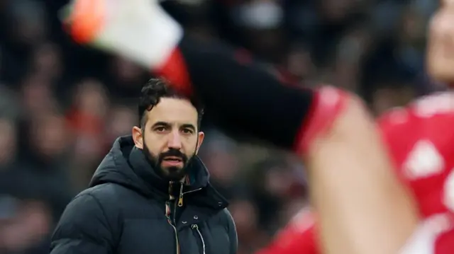 Manchester United manager Ruben Amorim looks on