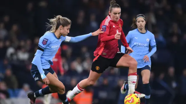 Grace Clinton of Manchester United (R) is challenged by Laia Aleixandri of Manchester City during the Barclays Women's Super League match between Manchester City and Manchester United at Etihad Stadium