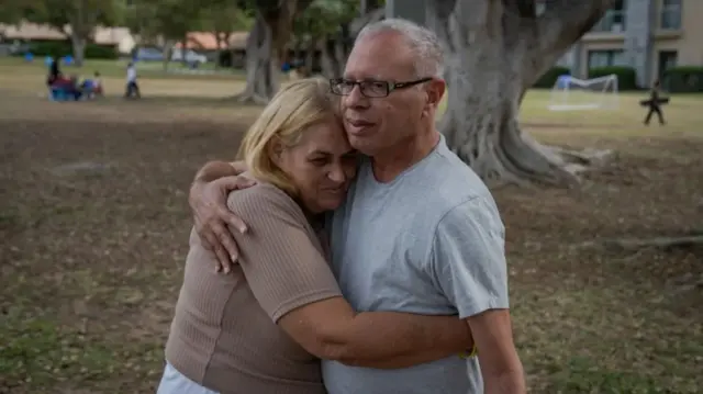 Doron’s mother Simona, hugging Avi Shariz. Shamriz’s son Alon was also taken hostage but was shot dead by the IDF by mistake.