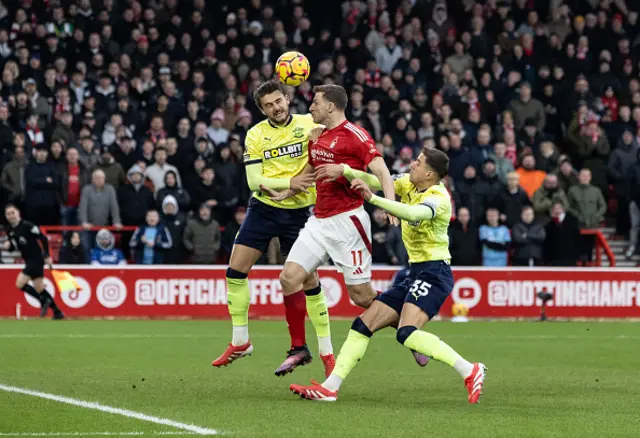 Nottingham Forest's Chris Wood (centre) is thwarted by Southampton's Taylor Harwood-Bellis