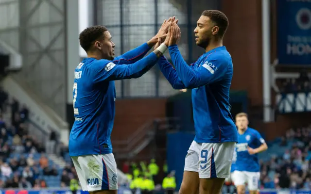 James Tavernier congratulates goalscorer Cyriel Dessers