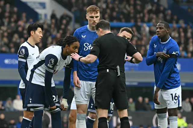 Players listen to English referee Darren England