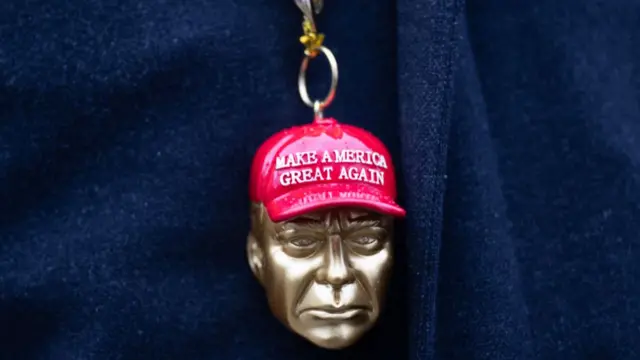 A pendant of Trump's head wearing a "Make America Great Again" cap