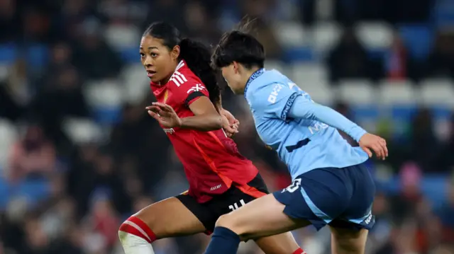 Manchester United's Jayde Riviere in action with Manchester City's Aoba Fujino