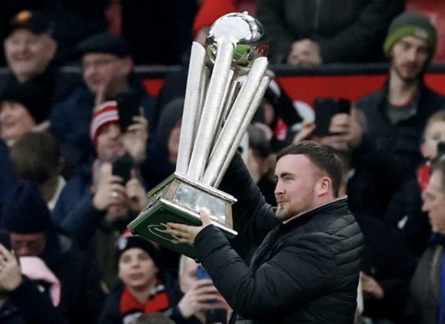 Luke Littler with the 2025 PDC World Darts Championship trophy