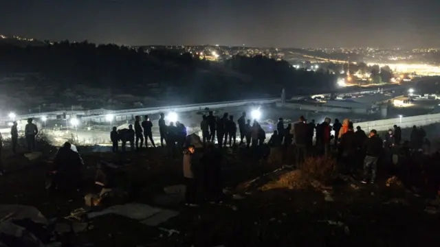 People wait on a hill outside the Ofer prison near Ramallah in the occupied West Bank