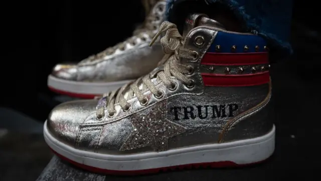 A pair of high-top trainers with stars and stripes on them and "Trump" printed on the side