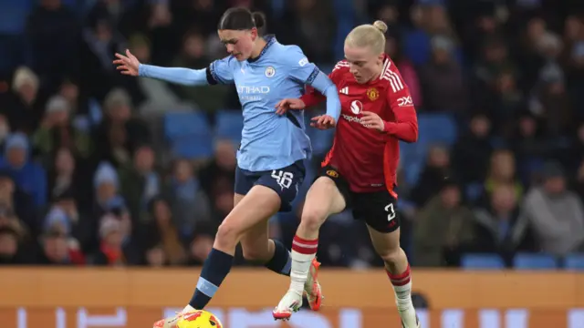 Lily Murphy of Manchester City (L) is challenged by Anna Sandberg of Manchester United during the Barclays Women's Super League match between Manchester City and Manchester United at Etihad