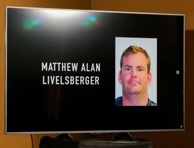 A TV screen with a photo of Livelsberger and his name spelled out in its entirety