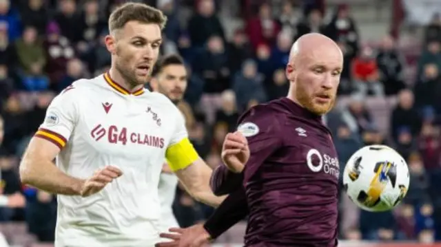 Motherwell captain Stephen O'Donnell with Hearts' Liam Boyce