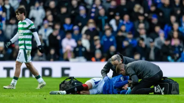 GLASGOW, SCOTLAND - JANUARY 02: Rangers' Ianis Hagi goes down with an injury after a challenge by Celtic's Alistair Johnston during a William Hill Premiership match between Rangers and Celtic at Ibrox Stadium, on January 02, 2025, in Glasgow, Scotland.  (Photo by Craig Foy / SNS Group)