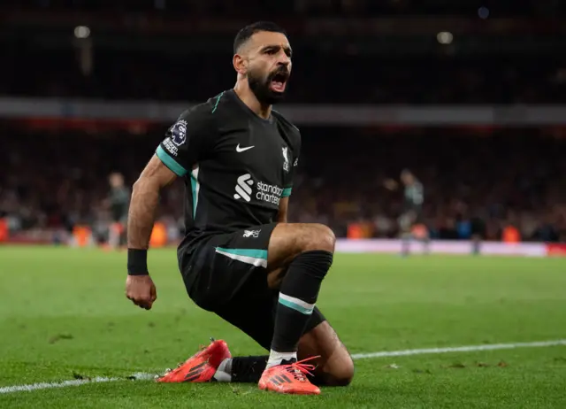 Mohamed Salah knee sliding at the Emirates Stadium