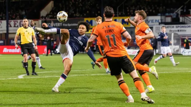 DUNDEE, SCOTLAND - JANUARY 02: Dundee’s Oluwaseun Adewumi has a shot during a William Hill Premiership match between Dundee and Dundee United at the Scot Foam Stadium at Dens Park, on January 02, 2025, in Dundee, Scotland.  (Photo by Ross Parker / SNS Group)