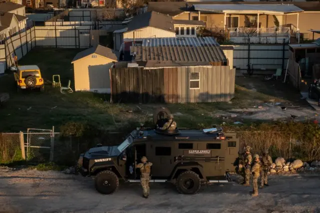 A drone view shows the Federal Bureau of Investigation (FBI) and Harris County law enforcement officials as they surround a residence in an armored vehicle in north Houston