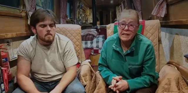 A woman with a younger man inside a narrowboat