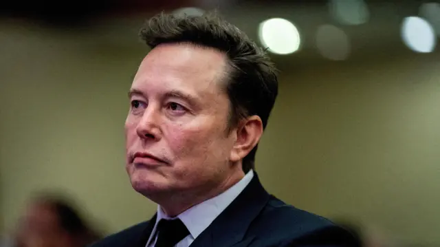 Tesla CEO and X owner Elon Musk listens as US President-elect Donald Trump speaks during a meeting with House Republicans at the Hyatt Regency hotel in Washington, DC