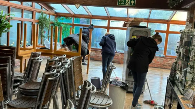 Staff mop up in the Secret Garden Cafe