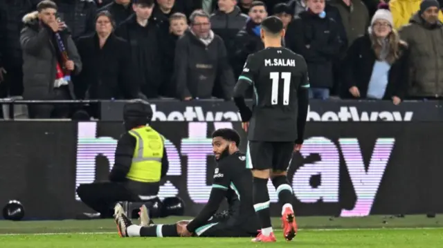 Mo Salah checks on Joe Gomez after the defender picks up a hamstring injury