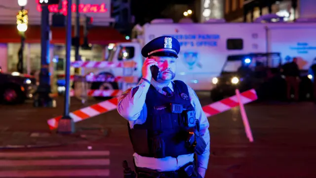 A law enforcement personnel stands near the site where people were killed by a man driving a truck in an attack during New Year's celebrations, in New Orleans, Louisian