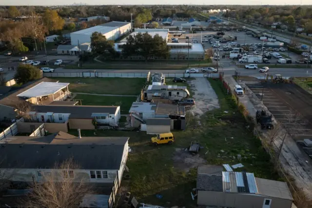 A drone view shows the Federal Bureau of Investigation (FBI) and Harris County law enforcement officials as they surround a residence in an armored vehicle in north Houston