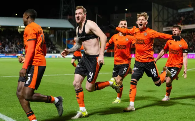 Dundee United's Kevin Holt (C) celebrates scoring to make it 1-0