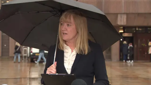 Ursula Doyle holding an umbrella