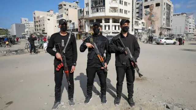 Hamas policemen stand guard after deploying in streets to maintain order in Gaza City