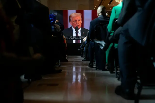 Guests and supporters are seen in an overflow room in Emancipation Hall as they watch Donald Trump being sworn in as the 47th President of the United States during his Inauguration ceremony at the U.S. Capitol on January 20, 2025 in Washington, DC. Donald Trump takes office for his second term as the 47th President of the United States