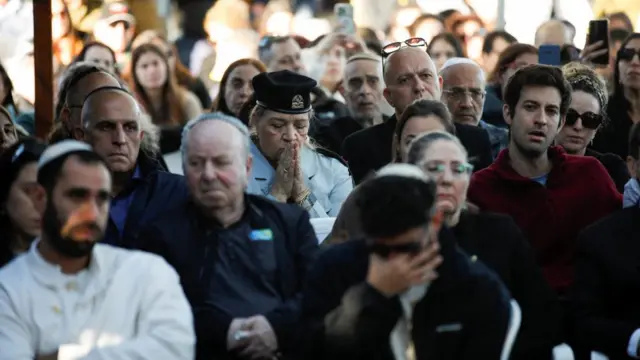 Crowd of mourners attending a funeral