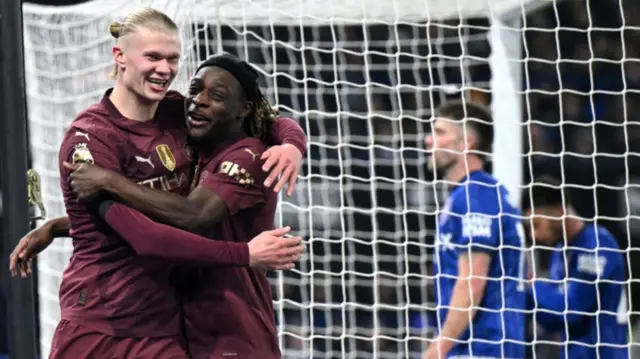 Haaland and Doku celebrate