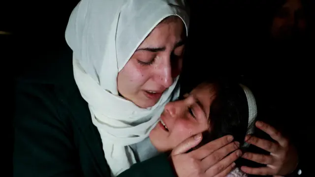 A freed Palestinian prisoner greets her child after her release