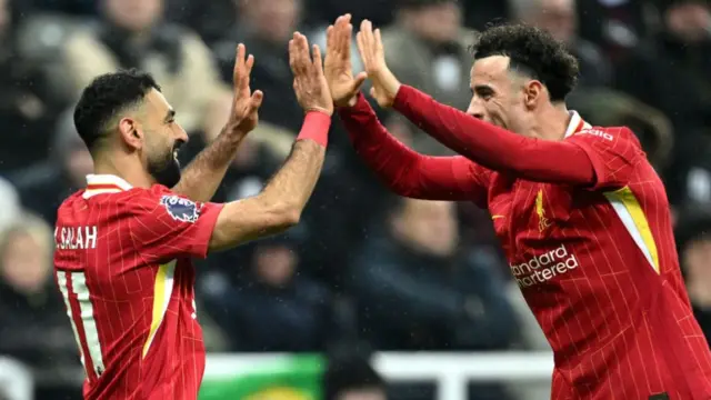 Mohamed Salah and Curtis Jones share a high-five