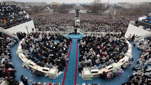 Trump addresses the crowd from a balcony on the US Capitol building