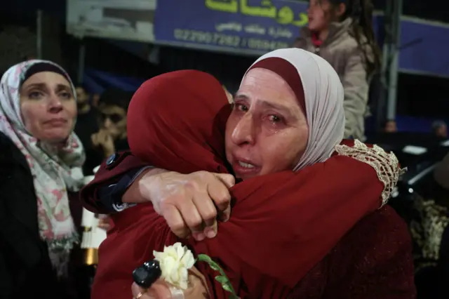 A Palestinian woman cries as she embraces a loved one who was released from jail