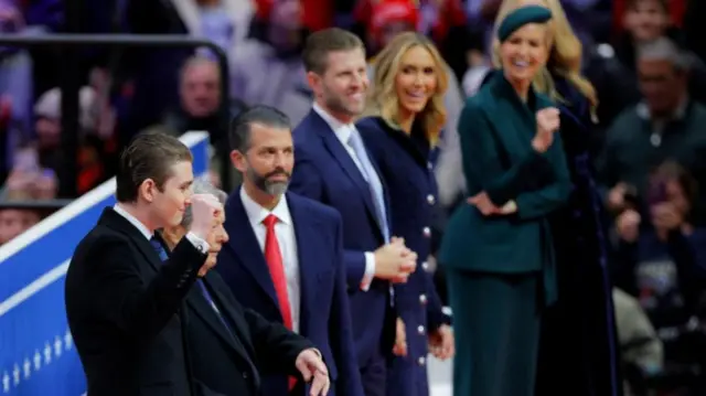 Barron Trump raises his fist alongside Donald Trump Jr, Eric Trump, Lara Trump and Ivanka Trump inside the Capital One arena