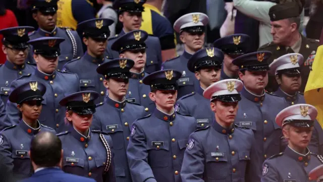 People in uniform march in the parade