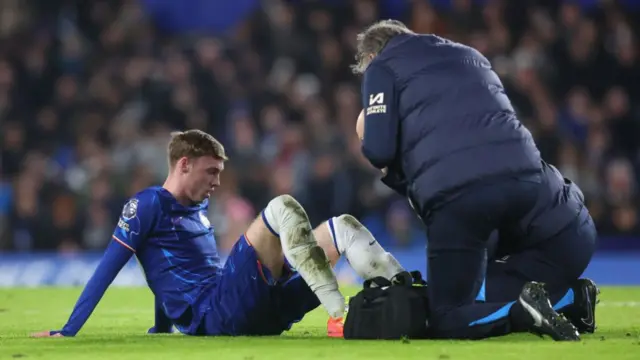 Cole Palmer of Chelsea receives treatment from the physio