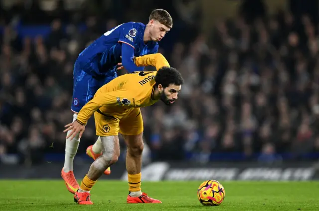 Ait nouri holds off a tackle from Palmer