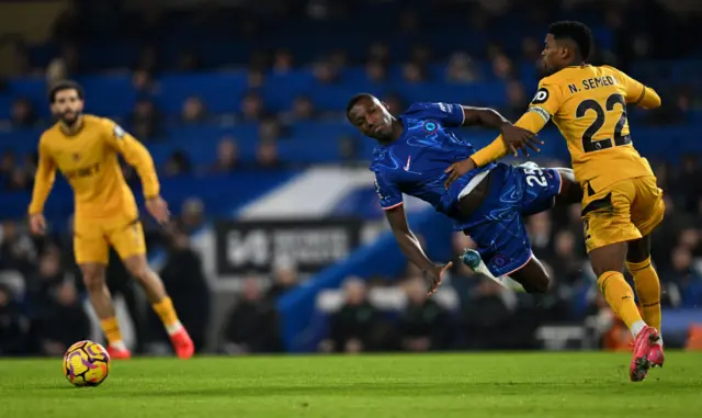 Caicedo is dragged to the floor by Semedo