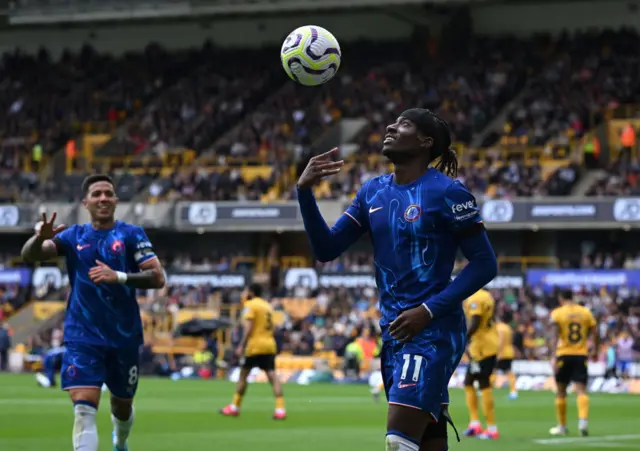 Noni Madueke throws the match ball in the air after scoring his hat-trick goal v Wolves