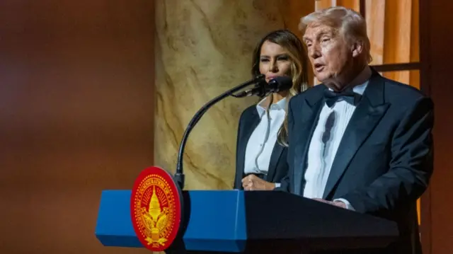 Donald and Melania Trump at a podium