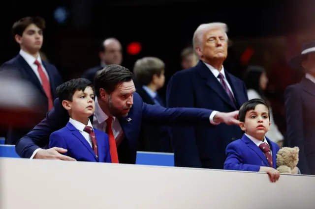 JD Vance points while his young sons look on