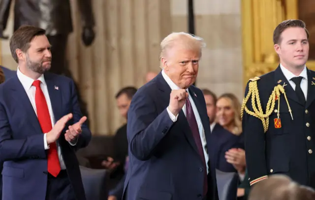 Donald Trump fist pumps as he leaves the rotunda