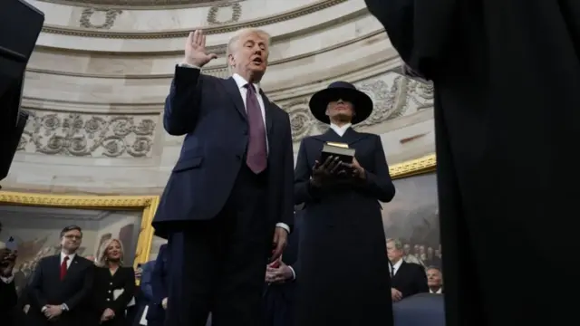 Donald Trump stands next to his wife, Melania, as he's sworn in as president