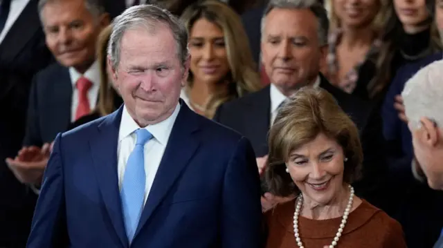 Former President George W. Bush gives a wink whilst attending at the Capitol Rotunda with former first lady Laura Bush