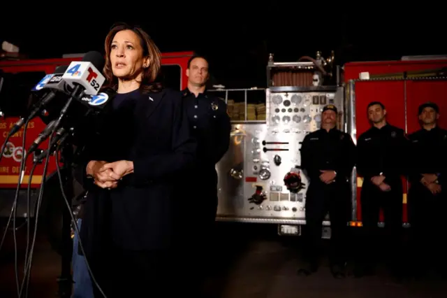 Kamala Harris stands in front of a microphone